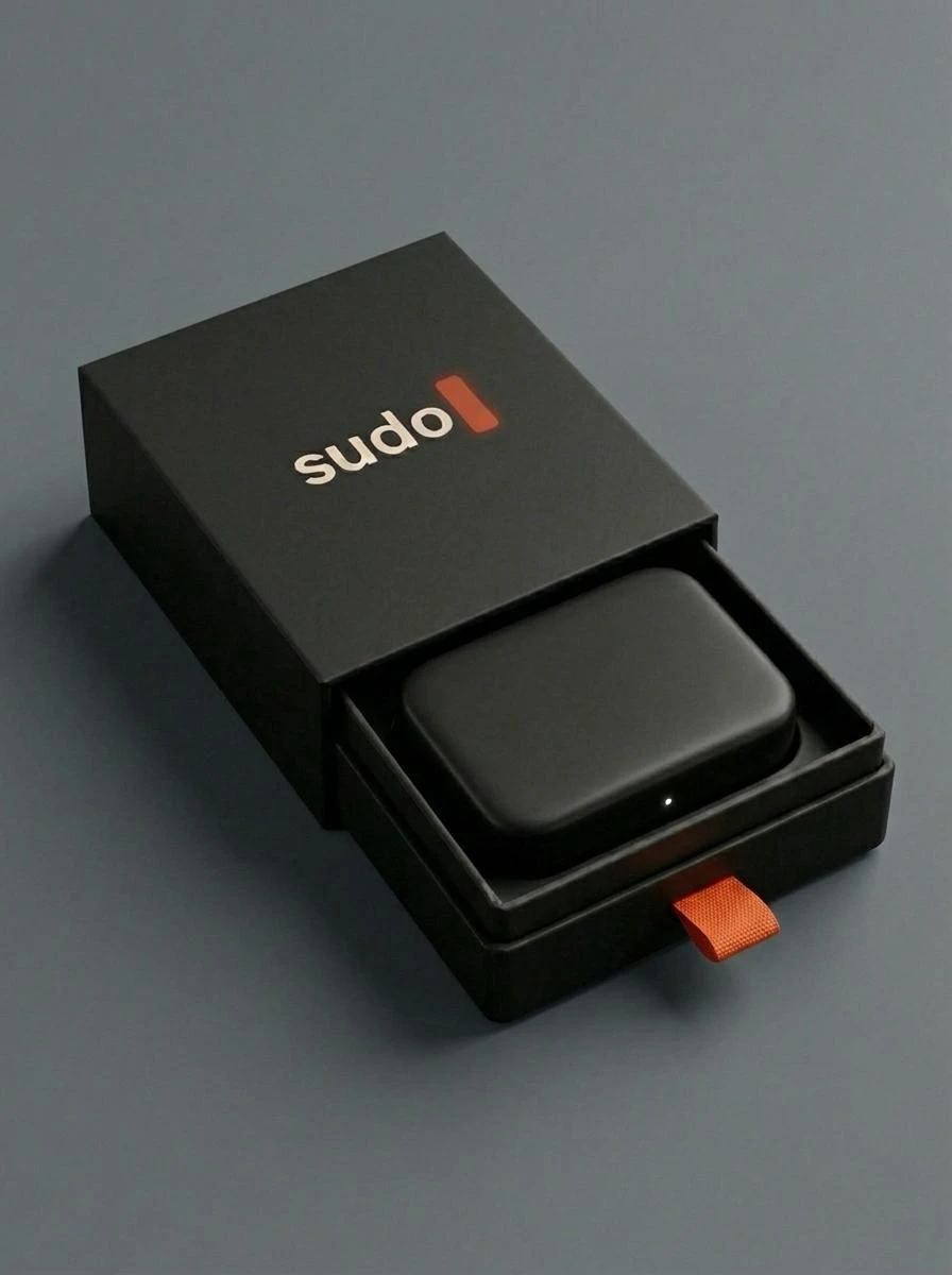 The sudo box: a matte black sliding box with the sudo wordmark and an orange pull tab, opened to show the small black device inside with a single white status light.